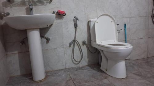 a bathroom with a shower and a toilet and a sink at WIJAYA Rest in Gampaha