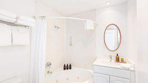 a white bathroom with a shower and a sink at 2 Coastal Studios at Cayucus Beach Access Ocean Views in Cayucos