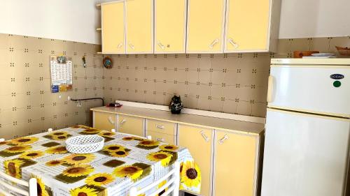 a kitchen with a table with sunflowers on it at SE081 - Comodo trilocale a Marotta in Marotta