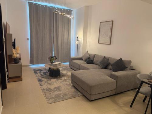 a living room with a couch and a table at Luxury 1BR on Reem Island Private Parking in Abu Dhabi