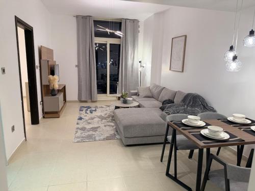 a living room with a couch and a table at Luxury 1BR on Reem Island Private Parking in Abu Dhabi