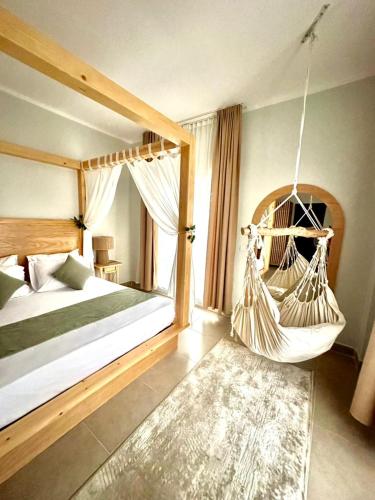 a bedroom with a hammock swing in a room at Babushka Boutique Hotel-Dahab in Dahab