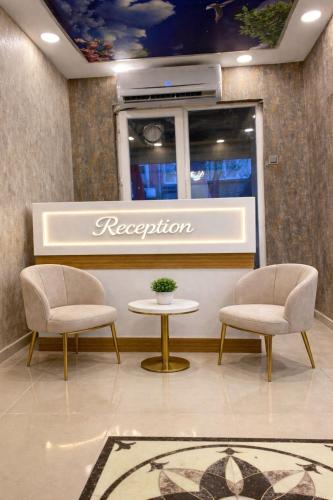 a reception area with two chairs and a table at Royal Fsm Suites in Istanbul