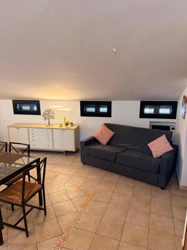 a living room with a black couch and a table at MARCONI APARTMENTS in Termoli