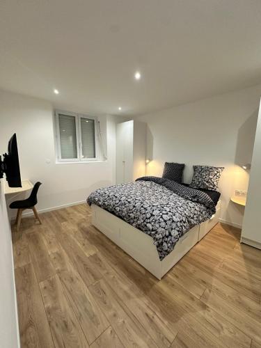 a bedroom with a bed and a wooden floor at Maison de ville a Berck in Berck-sur-Mer