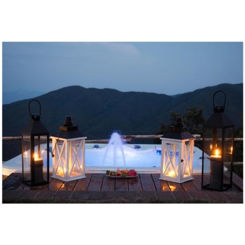 a swimming pool with lights and a fountain at Locanda Il Rustichello in Mulazzo