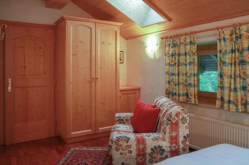 a living room with a chair and a window at Residence Salvan in Corvara in Badia