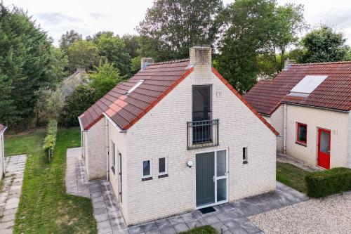 an aerial view of a white house with a red roof at 6 - Person Lake Area 28 Bungalow in Ewijk