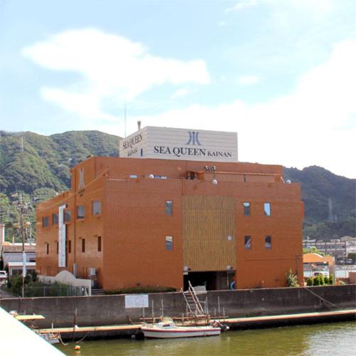 a building next to a marina with a boat in the water at Sea Queen Kainan in Kainan