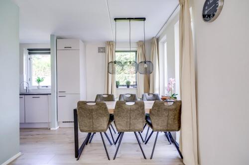 a dining room with a table and chairs at 6 - Persons Lake Area 40 Bungalow in Ewijk