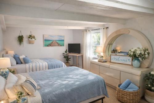 a bedroom with two beds and a mirror at Spacious Studio with Pool access & bathroom kitchen in West Palm Beach in West Palm Beach