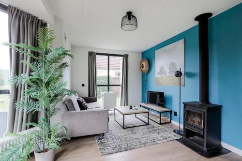 a living room with a couch and a fireplace at 6 - Persons Lakeside 7 Bungalow in Ewijk
