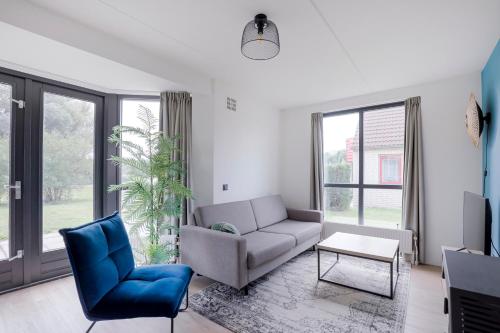a living room with a couch and a chair at 6 - Persons Lakeside 25 Bungalow in Ewijk