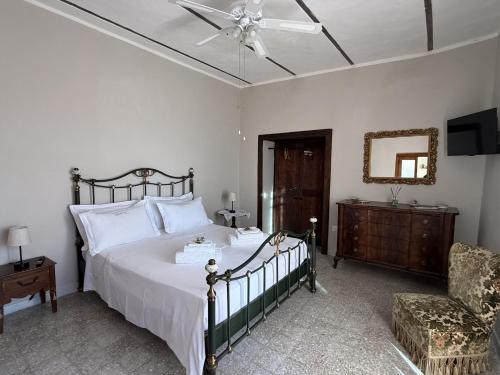 a bedroom with a bed and a ceiling fan at Tenuta degli Ulivi - Dimora Contadina in Montecorvino Rovella