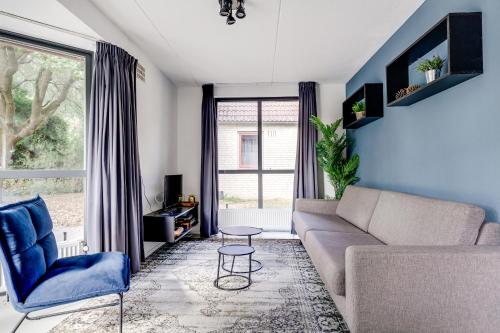 a living room with a couch and a window at 6 - Persons Lakeside 61 Bungalow in Ewijk