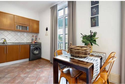 a kitchen with a table and chairs and a kitchen with a washing machine at House Bali Furnas in Furnas