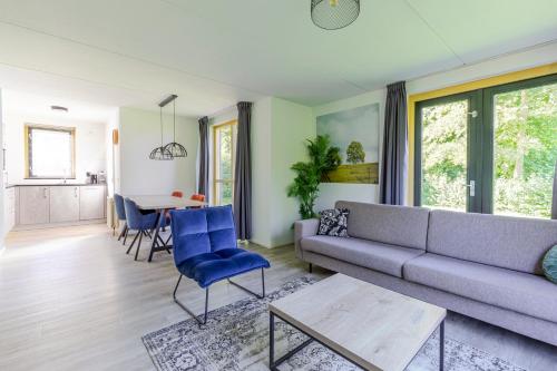 a living room with a couch and a table at 4-Person Forest 159 Bungalow in Ewijk