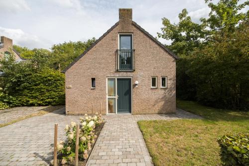 a brick house with a door and a window at 6 - Persoons Forest 67 Bungalow in Ewijk