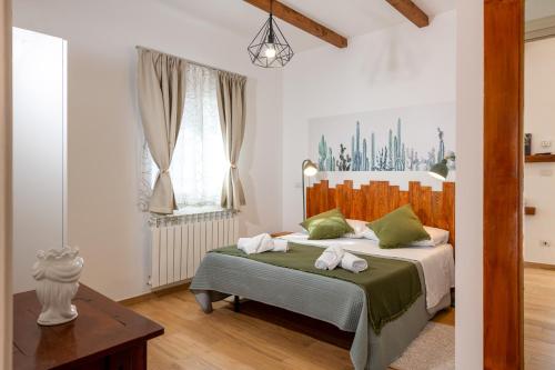 a bedroom with a bed with two towels on it at Agata's House in Viagrande