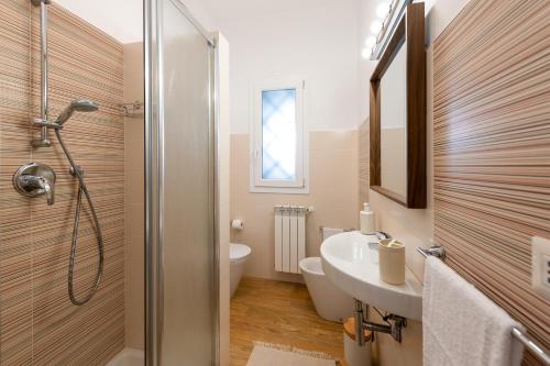 a bathroom with a sink and a toilet and a shower at Agata's House in Viagrande