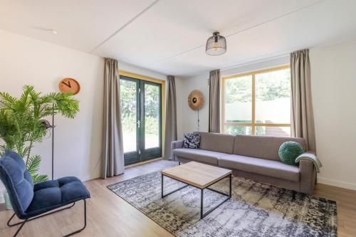 a living room with a couch and a table at 6 - Persoons Forest 151 Bungalow in Ewijk
