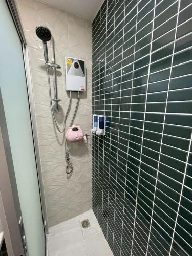 a bathroom with a shower with a shower head at The Lakefront Collective in Buriram, Thailand in Ban Nong Muang