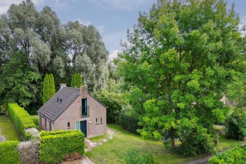 an aerial view of a small house in a garden at 6 - Persoons Forest 231 Bungalow in Ewijk