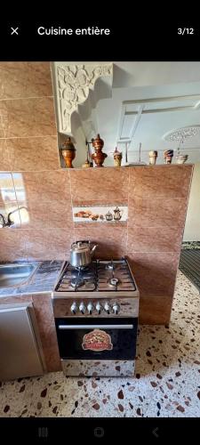 a kitchen with a stove with a pot on it at Taghazout beachside apartment in Agadir