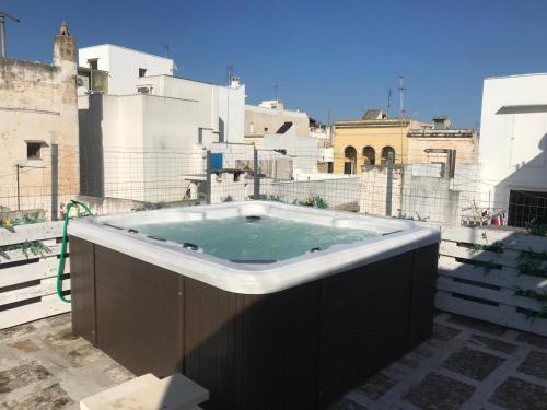 a hot tub sitting on top of a building at Equinox house in Tuglie