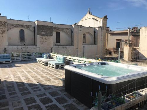 a hot tub on the roof of a building at Equinox house in Tuglie