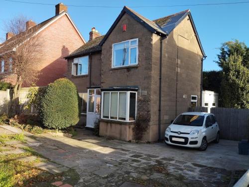 a white car parked in front of a house at Spacious 4 bed home to sleep 9, parking for 4 cars in Shrewsbury