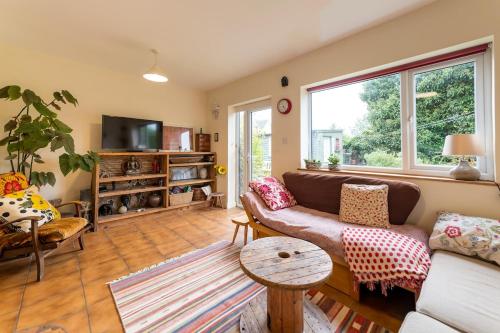a living room with a couch and a table at Spacious 4 bed home to sleep 9, parking for 4 cars in Shrewsbury