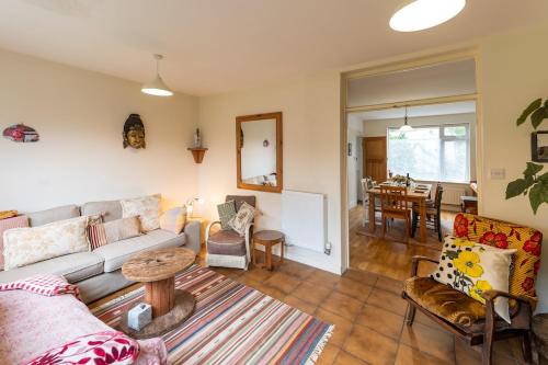 a living room with a couch and a table at Spacious 4 bed home to sleep 9, parking for 4 cars in Shrewsbury