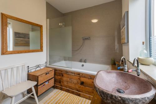 a bathroom with a large sink and a tub at Spacious 4 bed home to sleep 9, parking for 4 cars in Shrewsbury