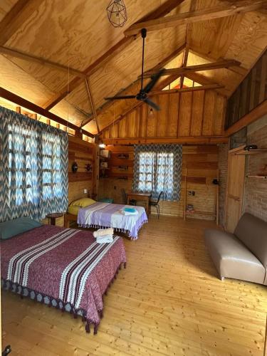 a large room with two beds and a couch at KAO Cabin in Brisas de Zicatela