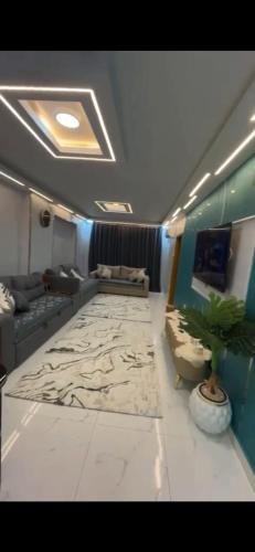 a living room with a couch and a large rug at شقة خاصة in Cairo
