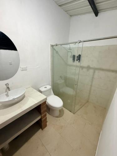 a bathroom with a shower and a toilet and a sink at Finca Campestre - Villa Esther con Piscina en Mesitas del Colegio in El Colegio