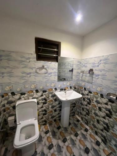 a bathroom with a toilet and a sink at Chill corner in Ahangama