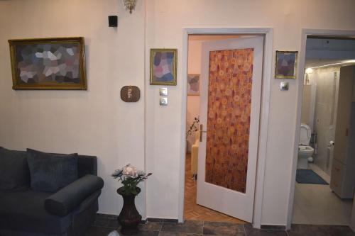 a living room with a couch and a door at Galleria Home in Serres