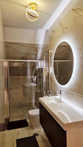a bathroom with a sink and a shower and a mirror at Cidadela do Viriato in Viseu