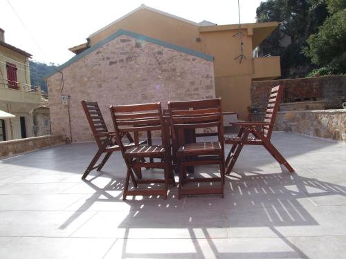 a group of chairs sitting around a table on a patio at Lovely in Lákka