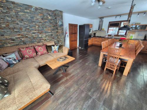 a living room with a couch and a table and a kitchen at Chata Marta in Boží Dar