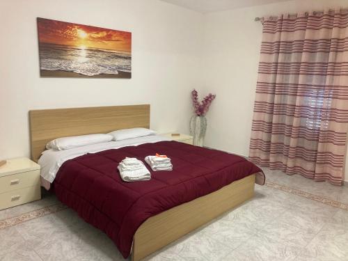 a bedroom with a bed with two towels on it at Casa Paradiso in Palazzo Adriano