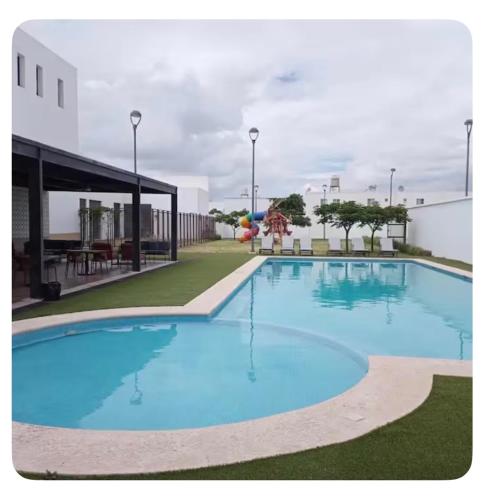 a large blue swimming pool in a building at Casa Completa Cómoda en el Sur in Santa Gertrudis