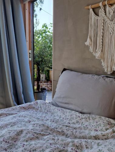 a bed in a bedroom with a window and a bedspread at FjordView Sanctuary in Nedstrand