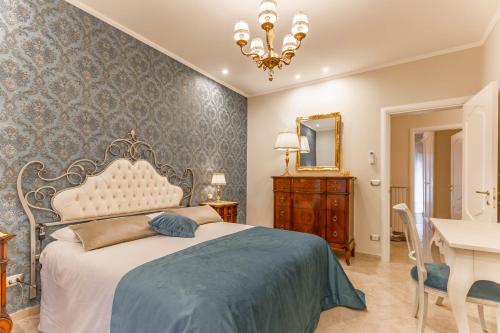 a bedroom with a bed and a desk and a mirror at Armea Suite Apartment in Trani