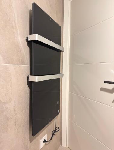 a bathroom with black shelves and a shower at LP House in Rovereto