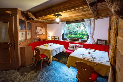 a dining room with two tables and a window at Hotel Gran Baita in Gressoney-Saint-Jean