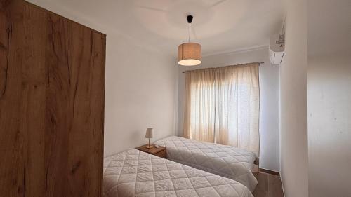 a bedroom with two twin beds and a window at Park Apartment - 2 Room APT in Lavradio
