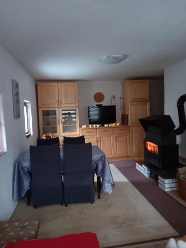 a living room with a table and a stove at Vikendica za odmor in Vlasic